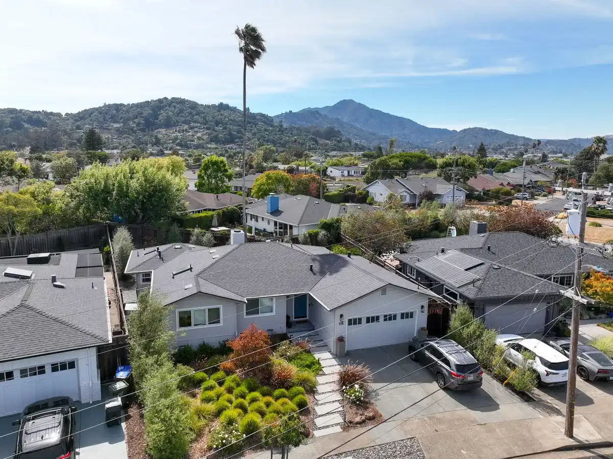 Single-story Marin County home with a gray architectural asphalt shingle roof, with Mount Tamalpais in the background.